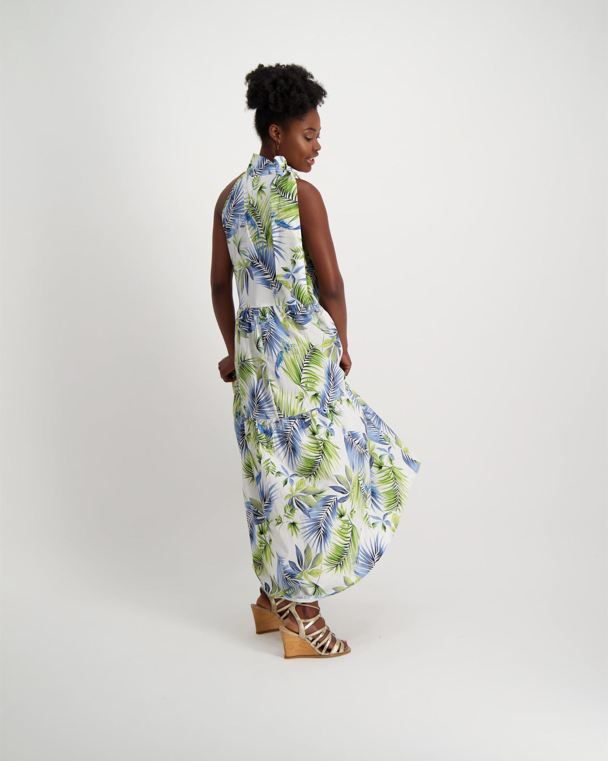 Gorgeous, hand-made, maxi-length halter neck dress, in fresh summer patterned fabric. Worn with wedge strap sandals.